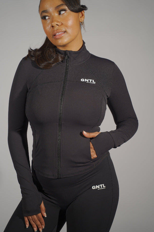 Black contour jacket displayed on a hanger against a plain background, highlighting its sleek fit and tailored design.